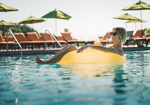Woman floating on a tube in the pool at Grand Geneva Resort and Spa
